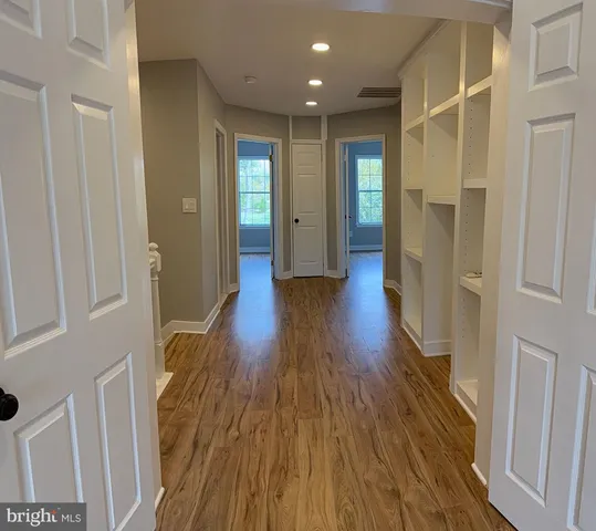 a view of hallway with wooden floor