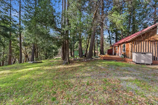a view of a house with yard and sitting area