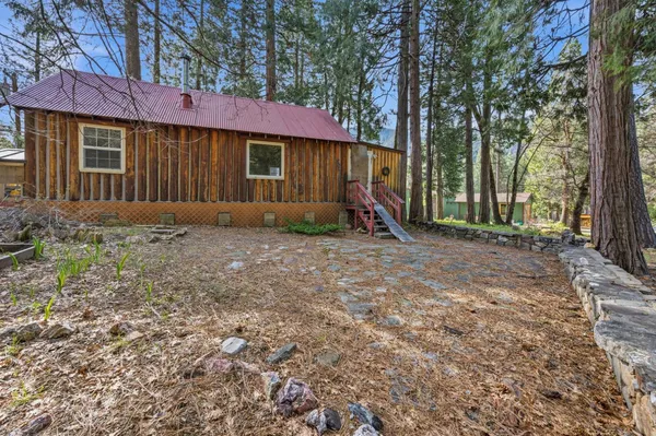 a backyard of a house with table and chairs