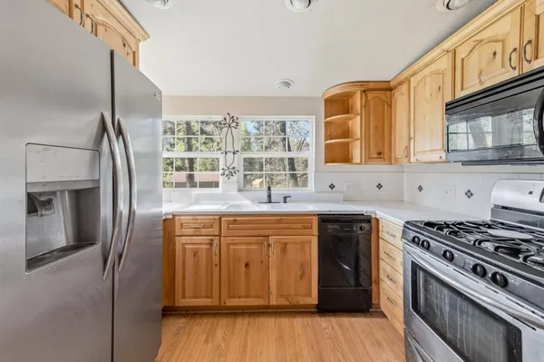 a kitchen with stainless steel appliances granite countertop a stove and a sink