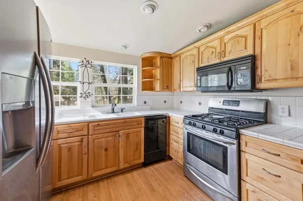 a kitchen with stainless steel appliances granite countertop a stove and a sink