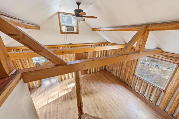 a view of an entryway with wooden floor