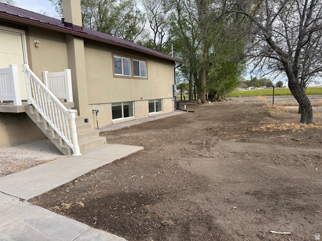 2865 North 3250 W Road Sutherland, UT 84624 - Photo 26 of 28 Stucco exterior with a brown metal roof