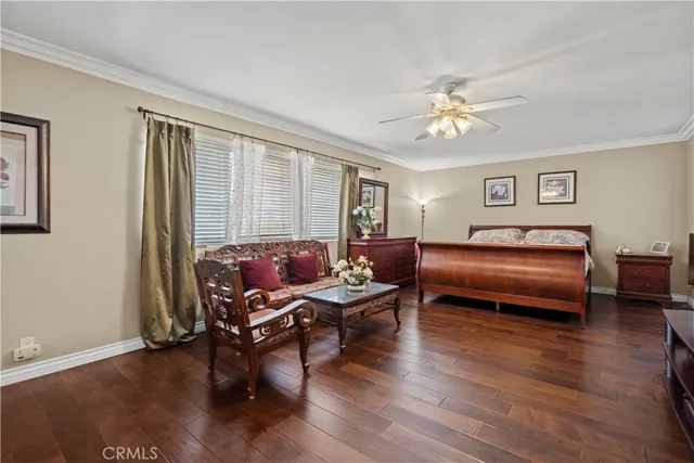 a living room with furniture a ceiling fan and a window