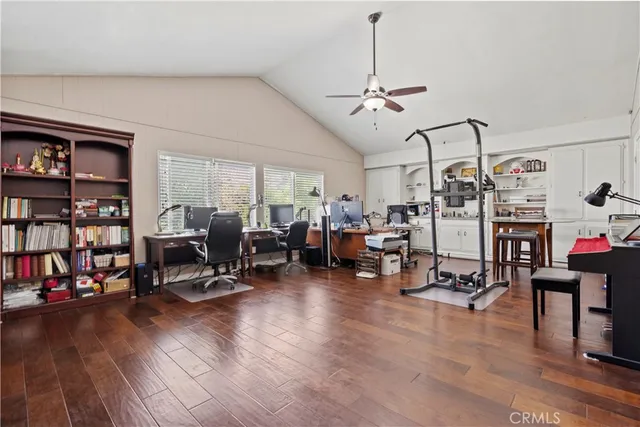 a view of a livingroom with workspace and a window