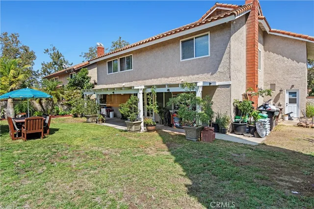 a view of a house with backyard porch and sitting area