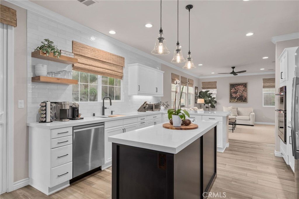 5156 Tahoe Place Rancho Cucamonga, CA 91739 - Photo 15 of 49 a kitchen with a sink stove and wooden floor