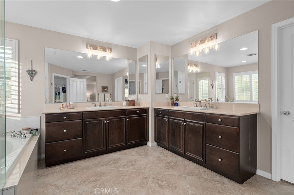 5156 Tahoe Place Rancho Cucamonga, CA 91739 - Photo 26 of 49 a spacious bathroom with a granite countertop double vanity and mirror