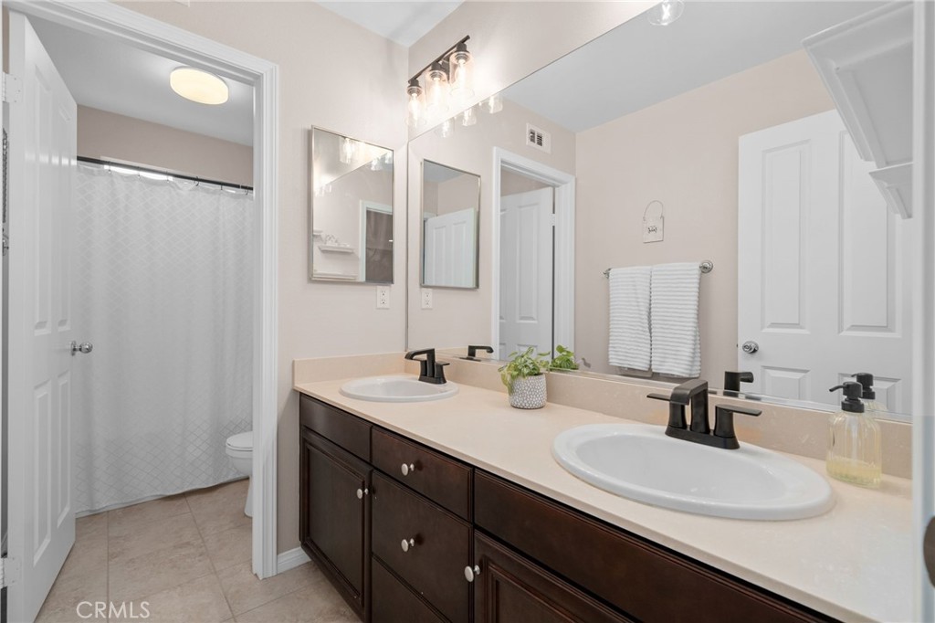 5156 Tahoe Place Rancho Cucamonga, CA 91739 - Photo 29 of 49 a bathroom with a double vanity sink mirror and double