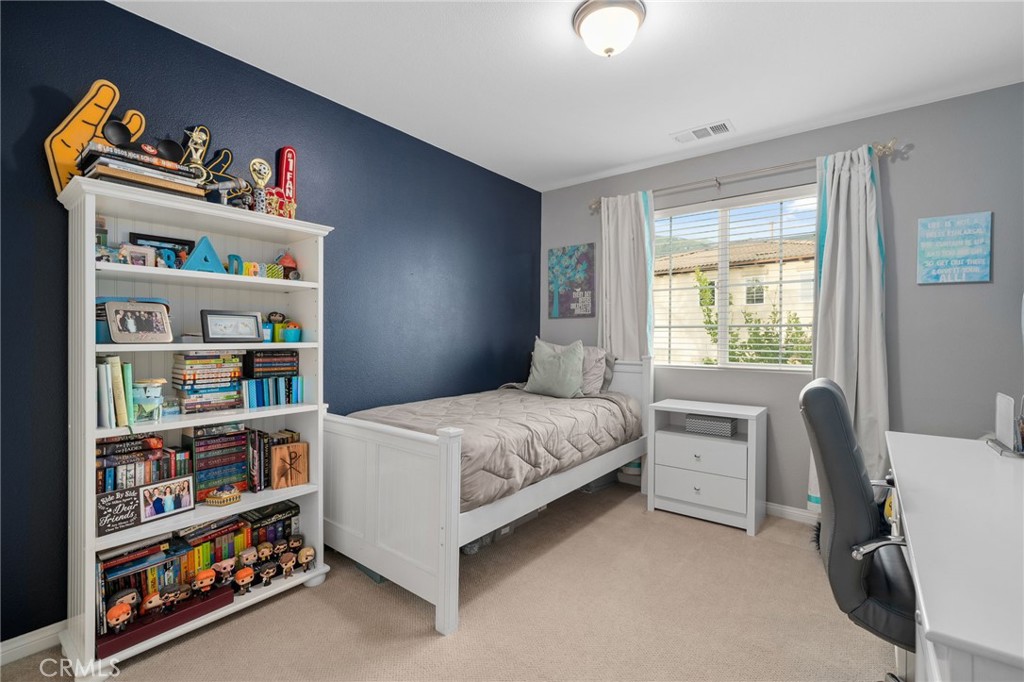 5156 Tahoe Place Rancho Cucamonga, CA 91739 - Photo 30 of 49 a bedroom with bed and a book shelf