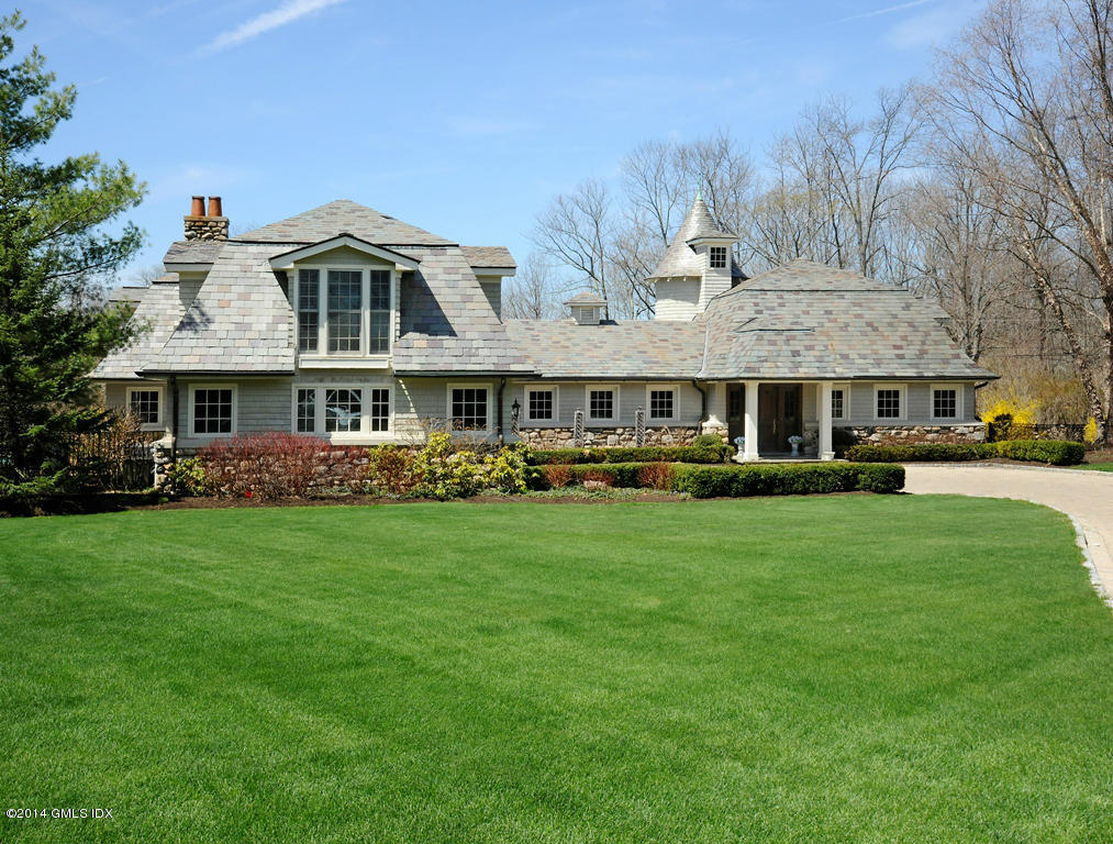 a front view of a building with a garden