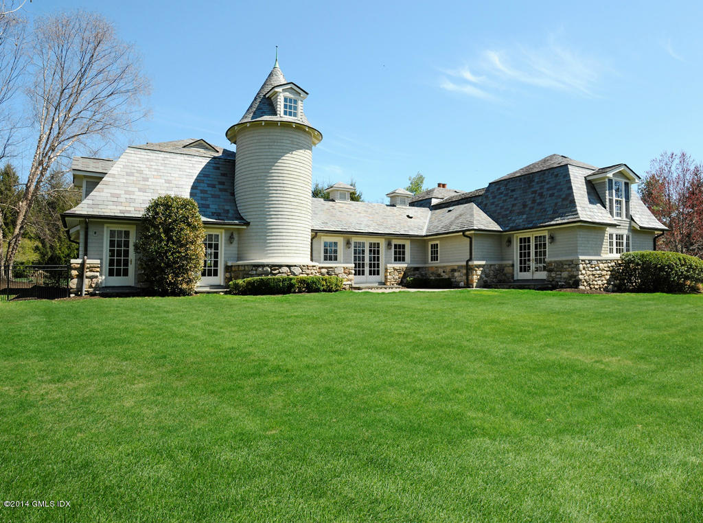 14 Chieftans Road Greenwich, CT 06831 - Photo 3 of 26 a front view of a house with a garden and trees