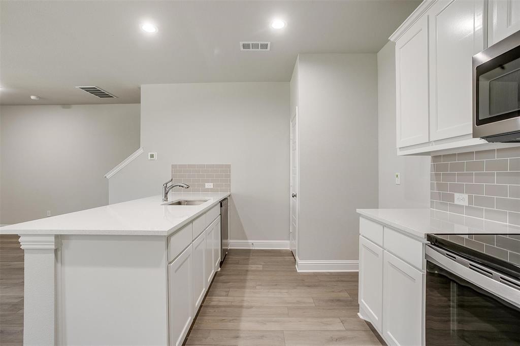 6807 Robert Reed Drive Arlington, TX 76001 - Photo 15 of 37 a utility room with cabinets washer and dryer