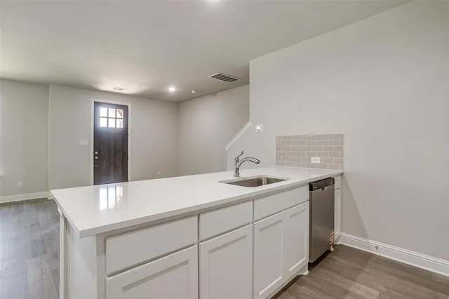 a utility room with cabinets washer and dryer