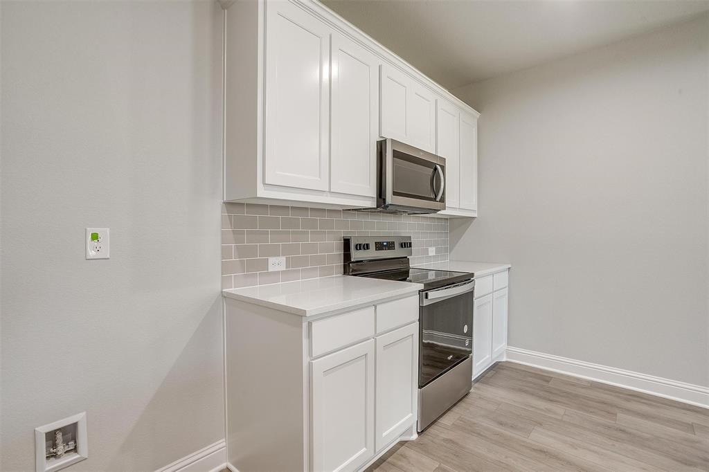 6807 Robert Reed Drive Arlington, TX 76001 - Photo 17 of 37 a kitchen with cabinets stainless steel appliances and a sink