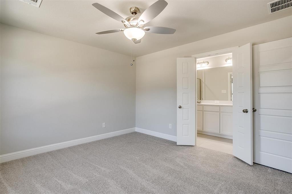 6807 Robert Reed Drive Arlington, TX 76001 - Photo 23 of 37 an empty room with a ceiling fan and a bathroom