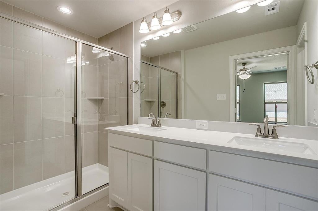 6807 Robert Reed Drive Arlington, TX 76001 - Photo 26 of 37 a bathroom with a sink double vanity and shower