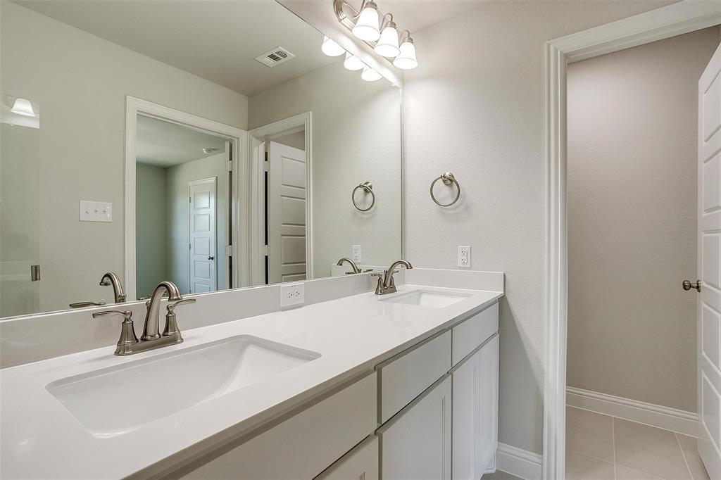 6807 Robert Reed Drive Arlington, TX 76001 - Photo 27 of 37 a bathroom with a sink and a mirror