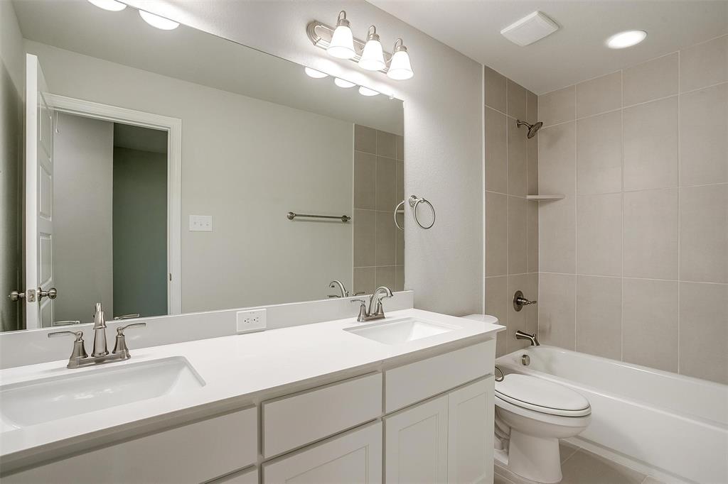 6807 Robert Reed Drive Arlington, TX 76001 - Photo 30 of 37 a bathroom with a double vanity sink toilet and a mirror