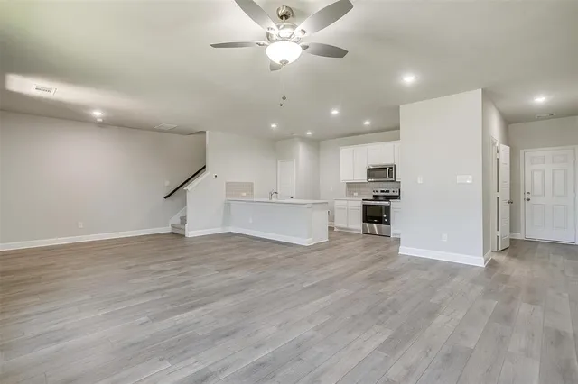 a view of kitchen with wooden floor and electronic appliances