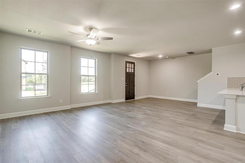 6807 Robert Reed Drive Arlington, TX 76001 - Photo 8 of 37 a view of an empty room with wooden floor and a window