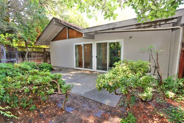 a view of a house with a yard and plants