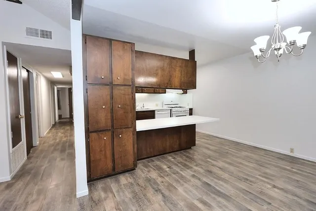 a view of a bathroom with a sink wooden cabinet and a mirror