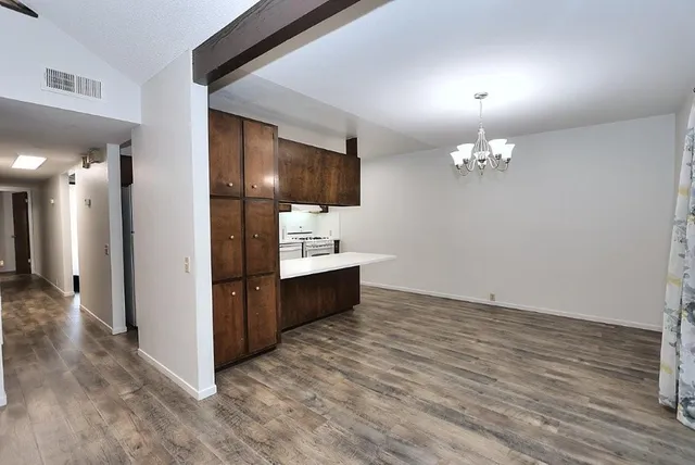 a view of kitchen with sink and refrigerator