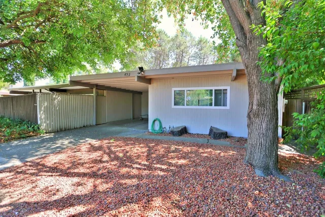 a view of a house with a tree in the background