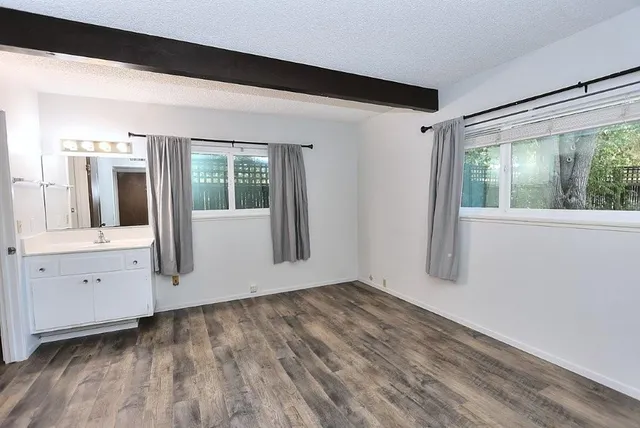 wooden floor in an empty room with a window