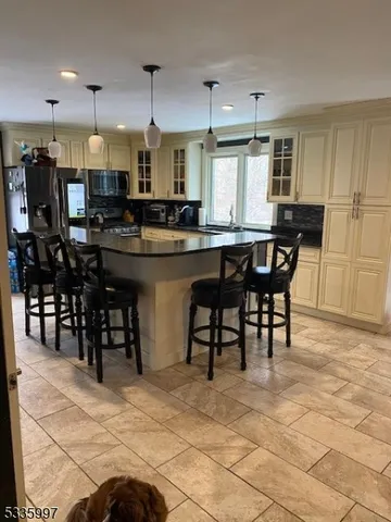 a kitchen with a dining table chairs and white cabinets