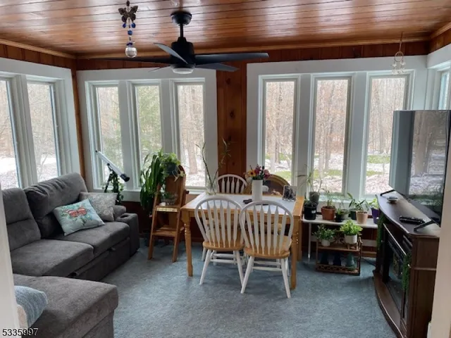 a living room with furniture and large windows
