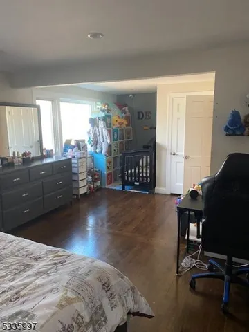 a bedroom with a bed closet and a window