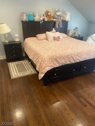 a bed sitting in a bedroom next to a lamp