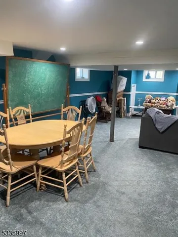 a living room with furniture gym equipment and a large window