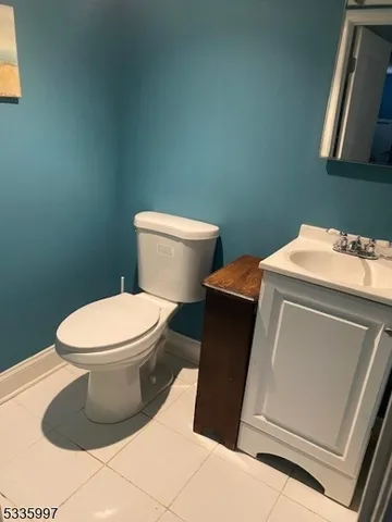 a white toilet sitting next to a sink