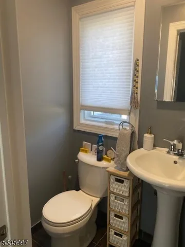 a bathroom with a sink toilet and mirror