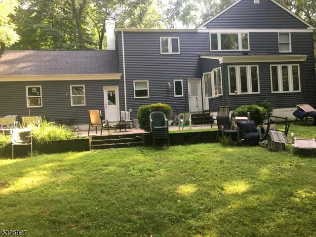 a front view of house with yard and outdoor seating
