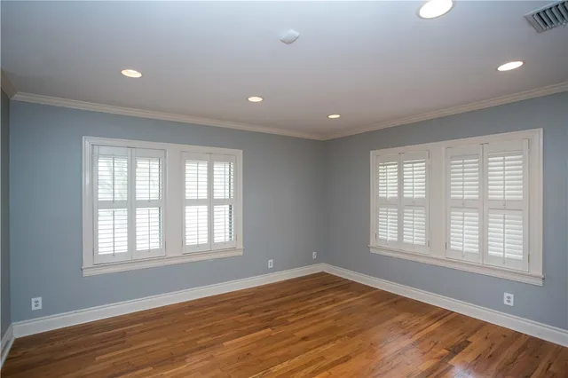 an empty room with windows and closet