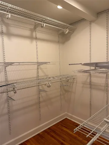 an empty room with closet and a window