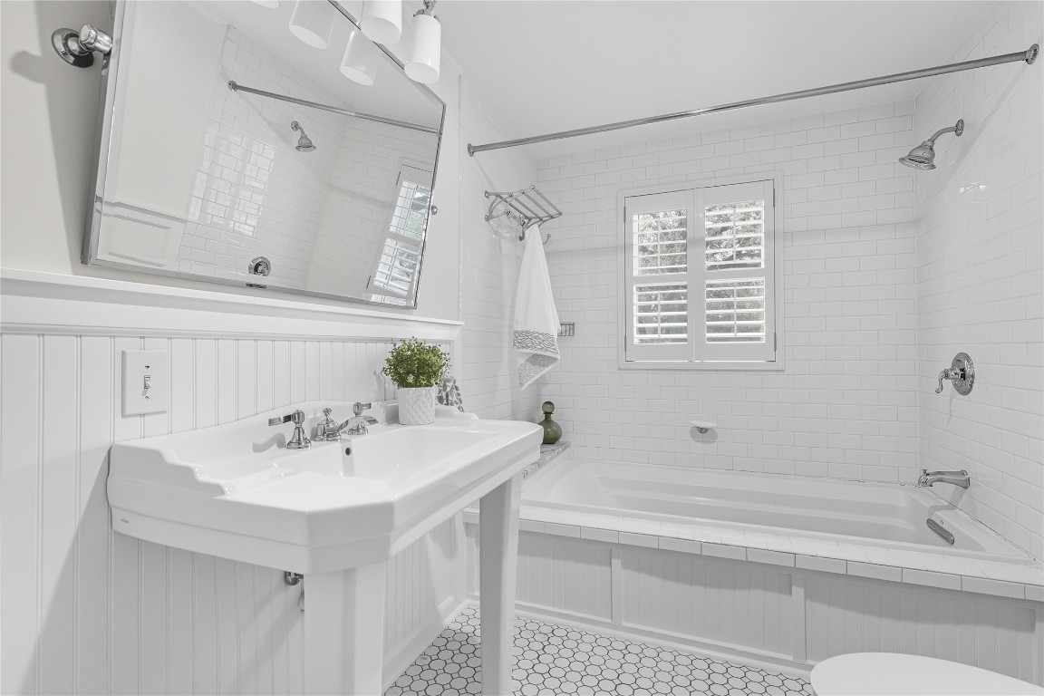 3003 Burleson Road Austin, TX 78741 - Photo 22 of 35 a bathroom with a sink a bathtub and a shower