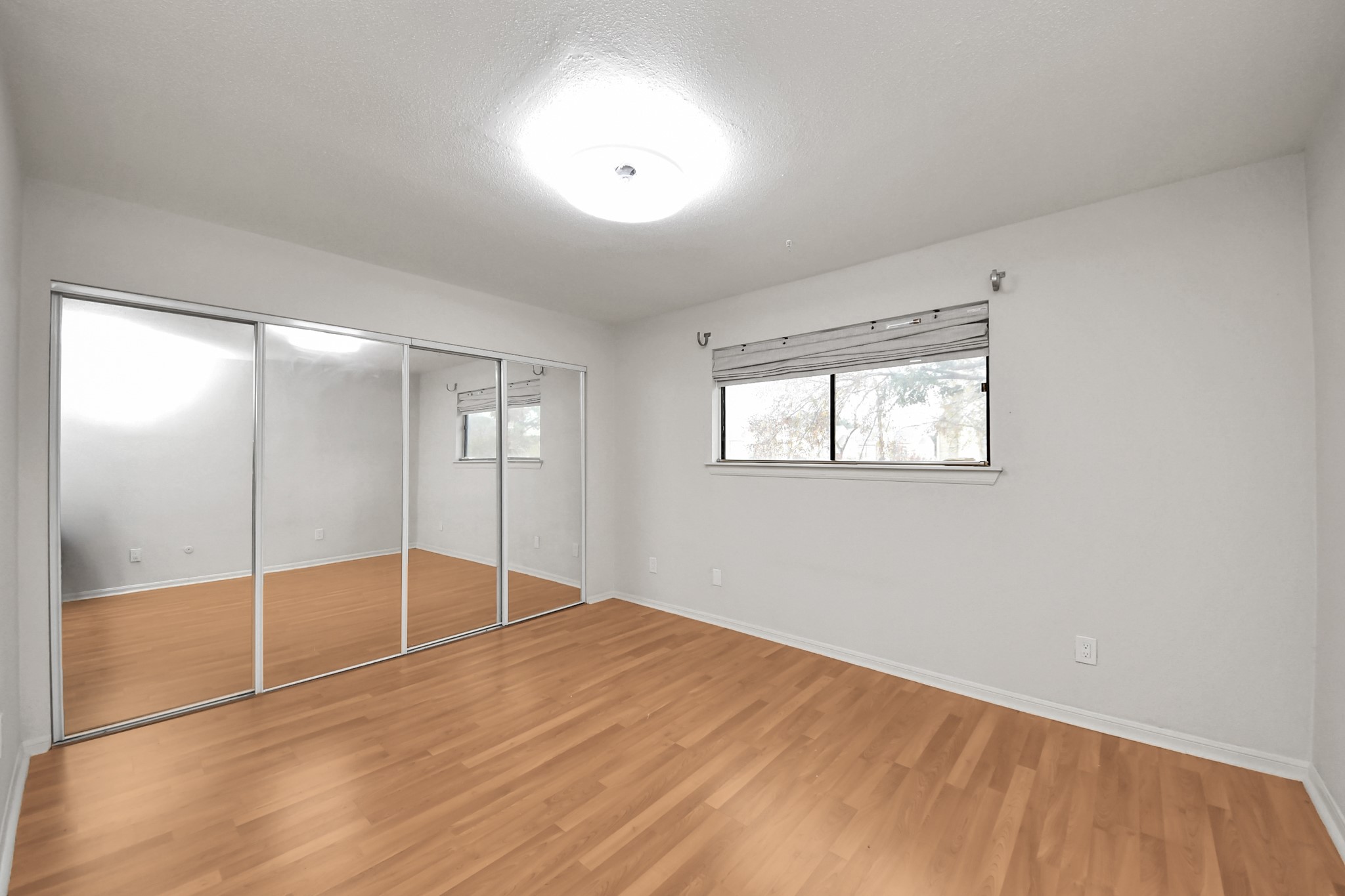 2425 Holly Hall Street, Unit C54 Houston, TX 77054 - Photo 12 of 24 a view of empty room with wooden floor and fan