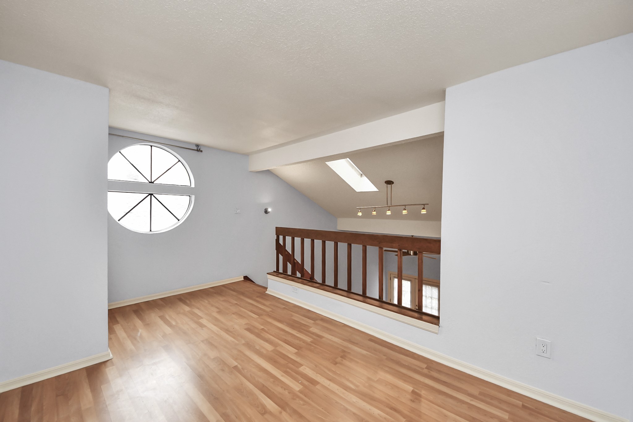 2425 Holly Hall Street, Unit C54 Houston, TX 77054 - Photo 15 of 24 an empty room with wooden floor cabinet and windows