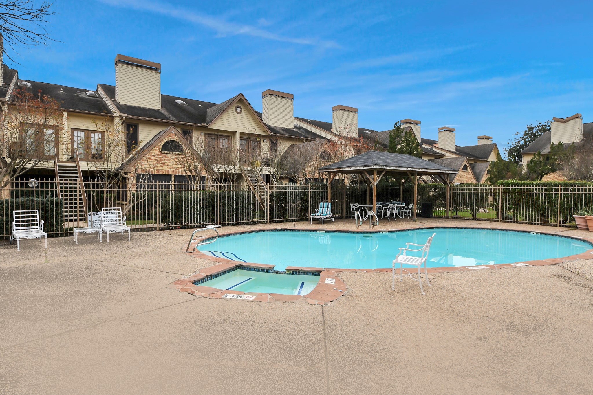 2425 Holly Hall Street, Unit C54 Houston, TX 77054 - Photo 22 of 24 front view of a house with swimming pool and porch