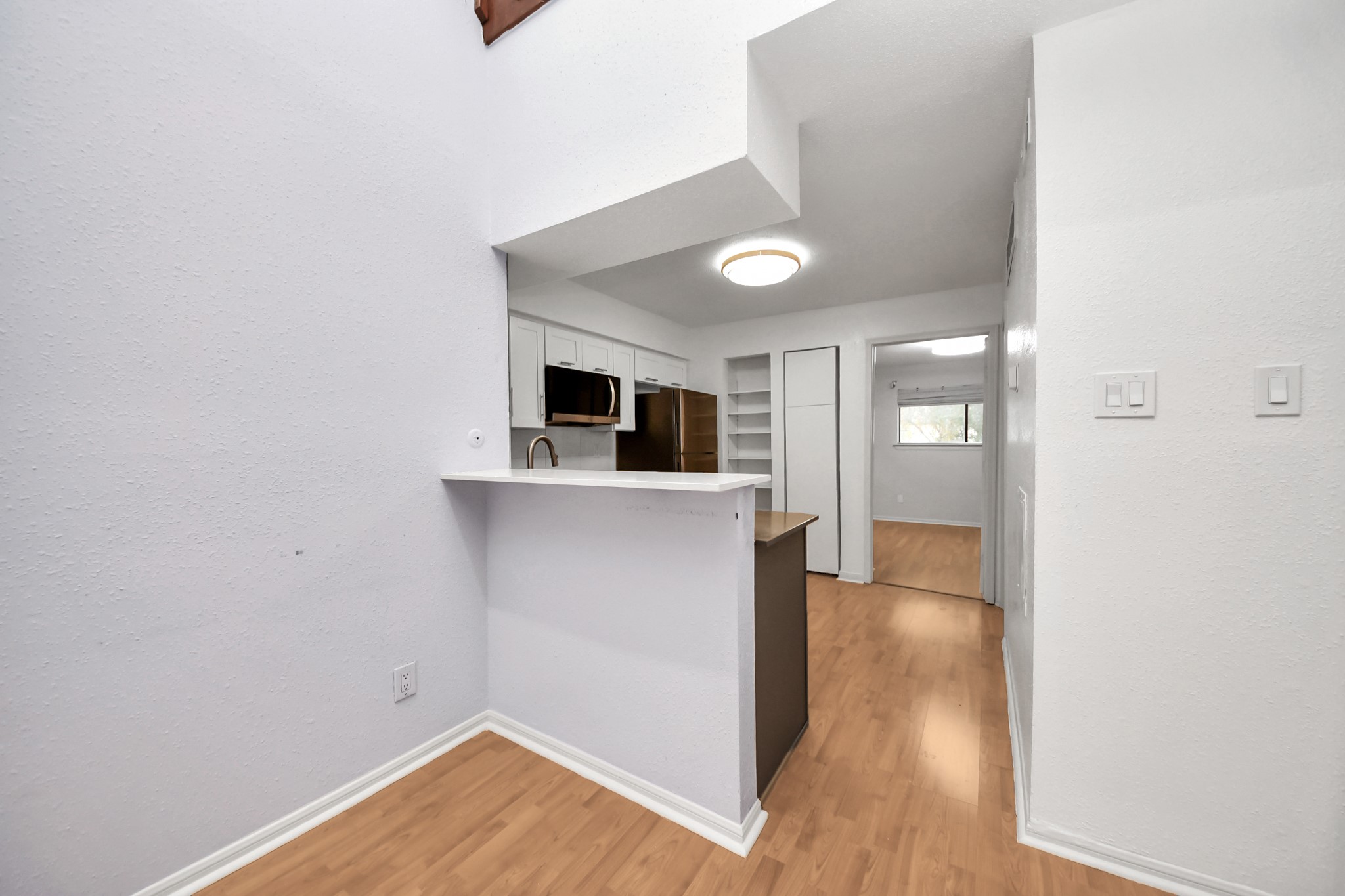2425 Holly Hall Street, Unit C54 Houston, TX 77054 - Photo 5 of 24 wooden floor in an empty room and a kitchen
