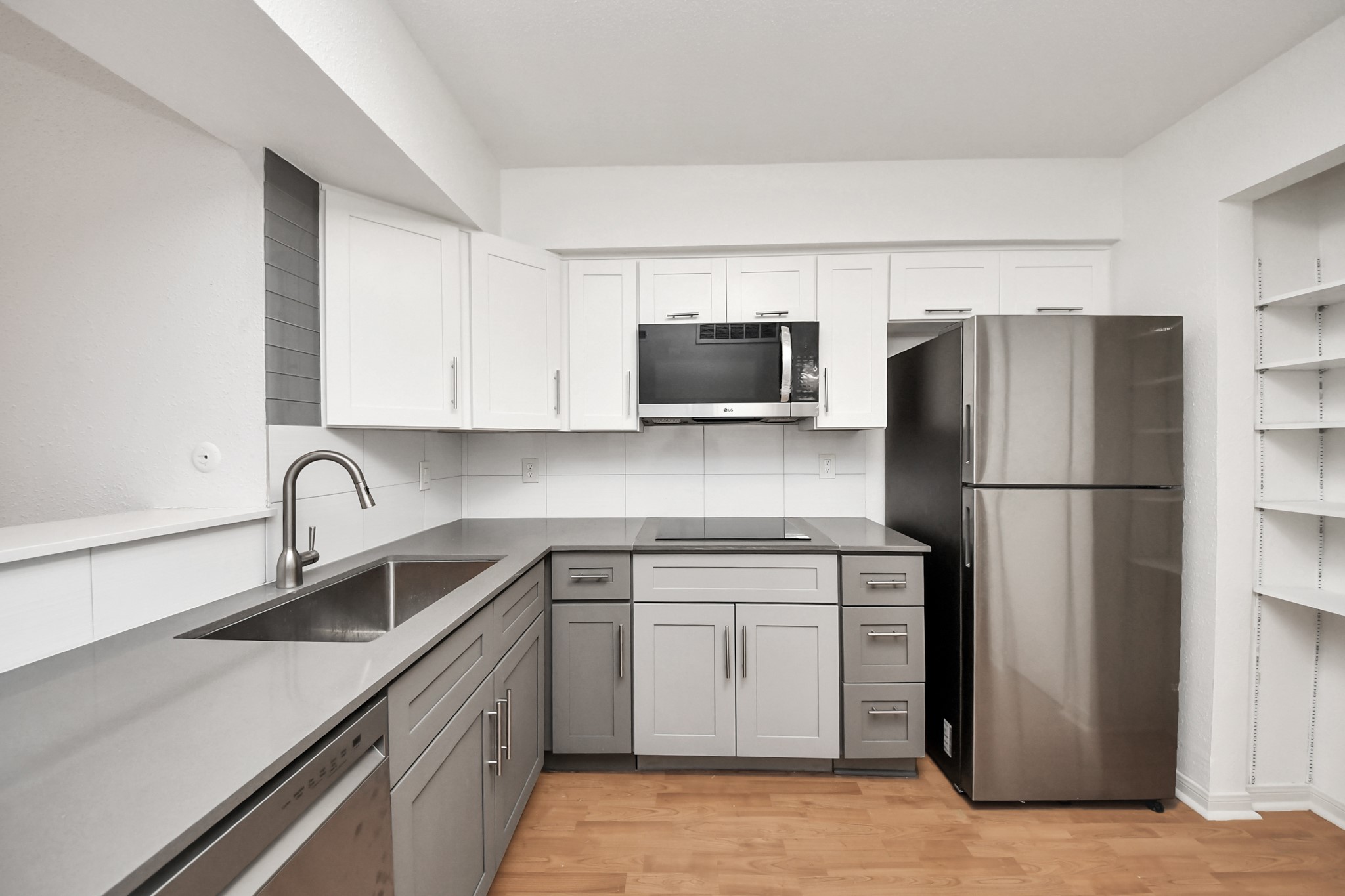 2425 Holly Hall Street, Unit C54 Houston, TX 77054 - Photo 7 of 24 a kitchen with stainless steel appliances granite countertop a refrigerator a stove a sink and white cabinets