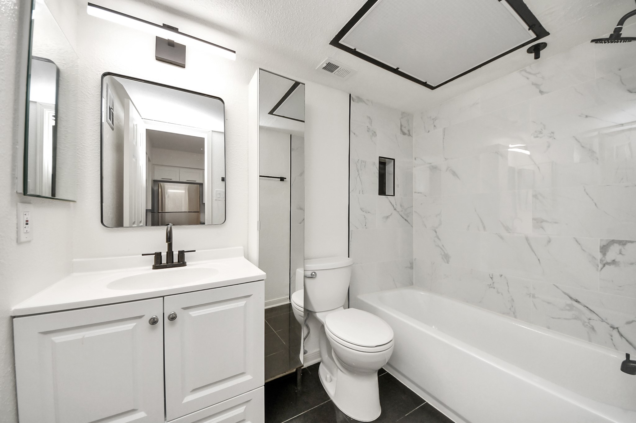 2425 Holly Hall Street, Unit C54 Houston, TX 77054 - Photo 9 of 24 a bathroom with a toilet sink vanity tub and shower