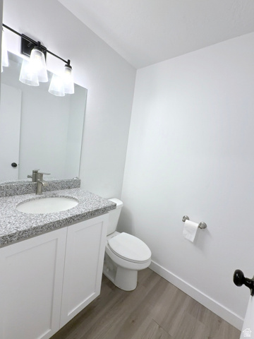 227 South West Lane Provo, UT 84601 - Photo 8 of 25 Bathroom featuring a white vanity with panel cabinetry, a granite-look countertop, and a circular undermount sink