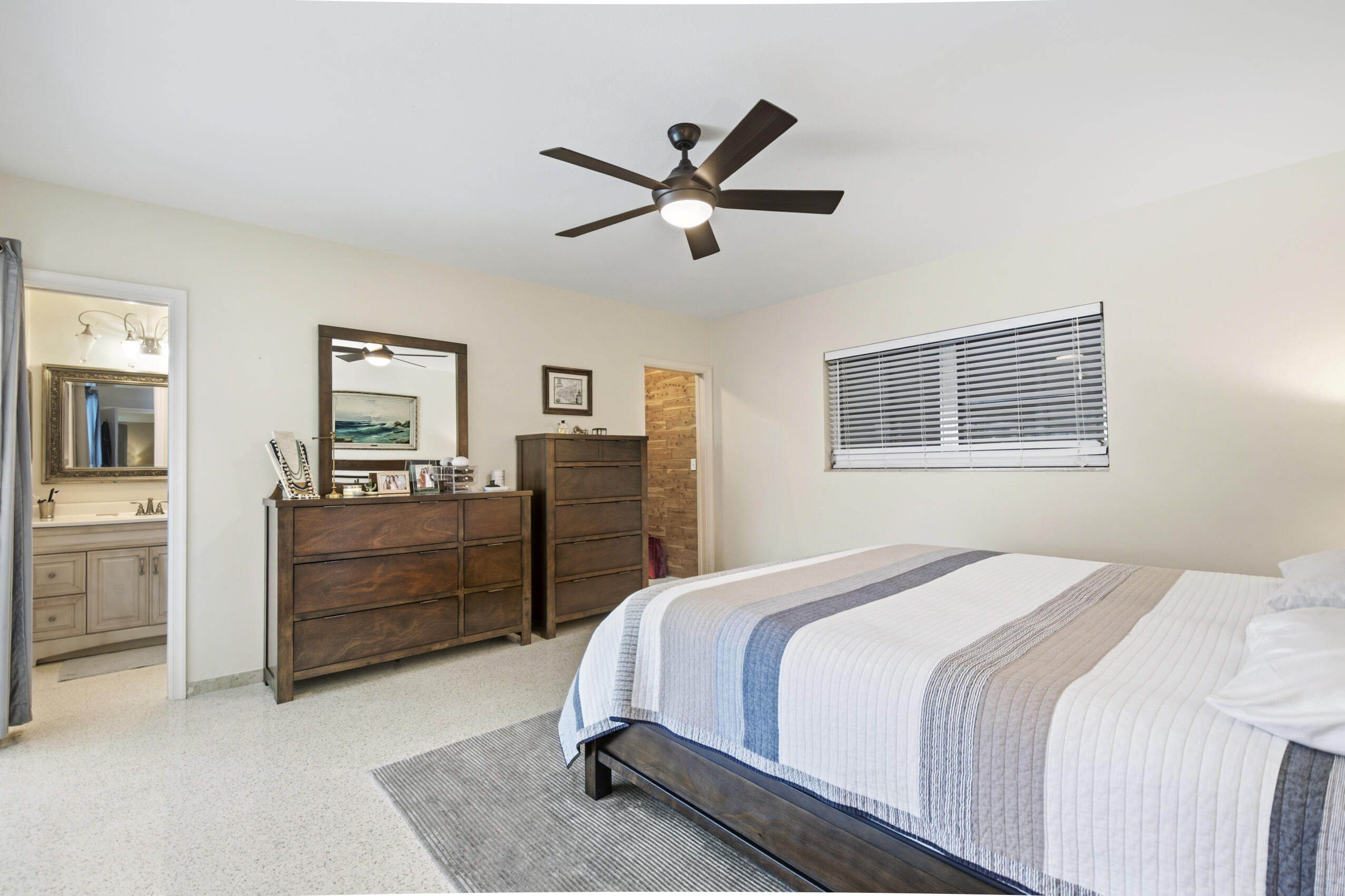 1348 Southwest 4th Street Boca Raton, FL 33486 - Photo 16 of 44 a bedroom with a bed and a chandelier