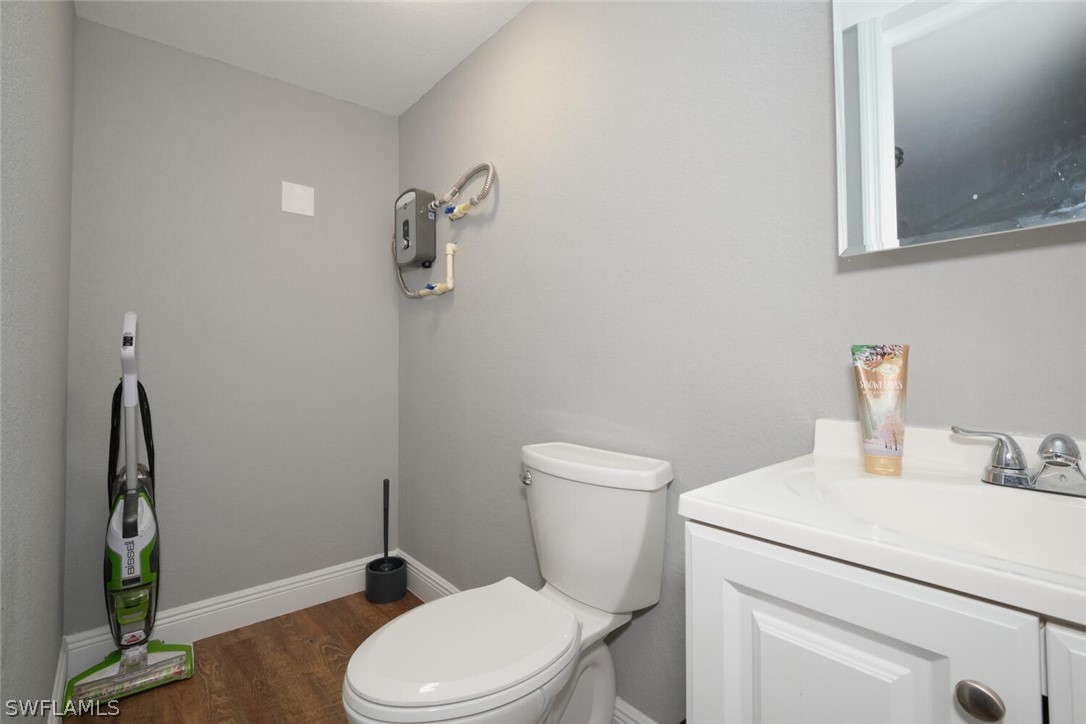 1322 Old Bridge Road North Fort Myers, FL 33917 - Photo 11 of 15 a white toilet sitting next to a bathroom sink